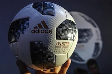 A participant holds the official match ball for the 2018 World Cup football tournament, named "Telstar 18", during its unveiling ceremony in Moscow on November 9, 2017.