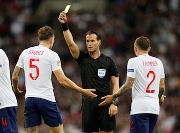 John Stones goes into the book.