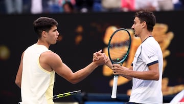 Tennis - Australian Open - Melbourne Park, Melbourne, Australia - January 18, 2024 Spain's Carlos Alcaraz shakes hands with Italy's Lorenzo Sonego after winning their second round match REUTERS/Eloisa Lopez