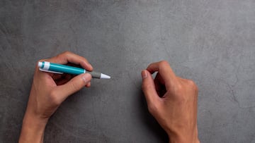 a woman left-hand with a pen.Left hander day concept.
