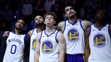 SAN FRANCISCO, CALIFORNIA - JANUARY 24: Gary Payton II #0, Jerome Robinson #18, Brandin Podziemski #2, Dario Saric #20 and Jonathan Kuminga #00 of the Golden State Warriors watch a video tribute for assistant coach Dejan Milojevic during a ceremony honoring Milojevic before their game against the Atlanta Hawks on January 24, 2024 at Chase Center in San Francisco, California. Dejan Milojevic died on Jan. 17 after suffering a heart attack. NOTE TO USER: User expressly acknowledges and agrees that, by downloading and or using this photograph, User is consenting to the terms and conditions of the Getty Images License Agreement.   Ezra Shaw/Getty Images/AFP (Photo by EZRA SHAW / GETTY IMAGES NORTH AMERICA / Getty Images via AFP)