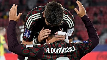 Mexico's midfielder #07 Alexei Dominguez celebrates with a teammate after scoring his team's first goal during the 2025 FIFA U20 World Cup football match between Brazil and Mexico at the National Stadium in Santiago on September 28, 2025. (Photo by RODRIGO ARANGUA / AFP)