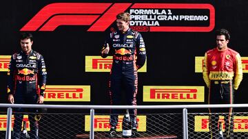 Second placed Red Bull Racing's Mexican driver Sergio Perez (L), first placed Red Bull Racing's Dutch driver Max Verstappen and third placed Ferrari's Spanish driver Carlos Sainz Jr celebrate on the podium after the Italian Formula One Grand Prix race at Autodromo Nazionale Monza circuit, in Monza on September 3, 2023. (Photo by Marco BERTORELLO / AFP)