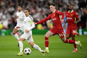 Liverpool's Northern Irish defender #84 Conor Bradley vies for the ball with Real Madrid's Croatian midfielder #10 Luka Modric during the UEFA Champions League football match between Liverpool and Real Madrid at Anfield in Liverpool, north west England on November 27, 2024. (Photo by Oli SCARFF / AFP)