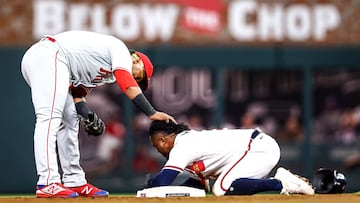 ATLANTA, GA - SEPTEMBER 17: Jean Segura #2 of the Philadelphia Phillies checks on an apparently injured Ozzie Albies #1 of the Atlanta Braves after Albies slid into second base in the bottom of the fourth inning of a game at Truist Park on September 17, 2022 in Atlanta, Georgia.   Casey Sykes/Getty Images/AFP