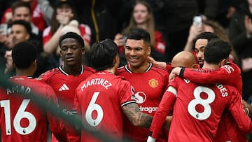 Manchester United's Brazilian midfielder #18 Casemiro (C) celebrates with teammates after scoring the team's first goal during the English Premier League football match between Manchester United and Fulham at Old Trafford in Manchester, north west England, on February 1, 2026. (Photo by Paul ELLIS / AFP) / RESTRICTED TO EDITORIAL USE. No use with unauthorized audio, video, data, fixture lists, club/league logos or 'live' services. Online in-match use limited to 120 images. An additional 40 images may be used in extra time. No video emulation. Social media in-match use limited to 120 images. An additional 40 images may be used in extra time. No use in betting publications, games or single club/league/player publications. /