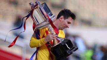 SEVILLE, SPAIN - APRIL 17: Lionel Messi of FC Barcelona walks off with the trophy after winning the Copa Del Rey Final match between Athletic Club and Barcelona at Estadio de La Cartuja on April 17, 2021 in Seville, Spain. Sporting stadiums around Spain r