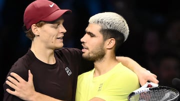 (FILES) Italy's Jannik Sinner (L) is congratulated by Spain's Carlos Alcaraz at the end of their men's single final match at the ATP Finals tennis tournament, in Turin, on November 16, 2025. Carlos Alcaraz and Jannik Sinner are gearing up for more world domination in 2026, starting at the Australian Open, while Aryna Sabalenka is bubbling with confidence as she chases further Grand Slam success. (Photo by Marco BERTORELLO / AFP)