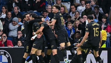 Valencia's Spanish forward #09 Hugo Duro (2L) celebrates with teammates after scoring their second goal during the Spanish league football match between Real Madrid CF and Valencia CF at the Santiago Bernabeu stadium in Madrid on April 5, 2025. (Photo by JAVIER SORIANO / AFP)