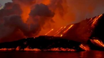 Lava glows and smoke rises as Cumbre Vieja volcano continues to erupt on the Canary Island of La Palma, Spain November 10, 2021 in this still image obtained from a social media video on November 11, 2021. Courtesy of Involcan/via REUTERS THIS IMAGE HAS BE