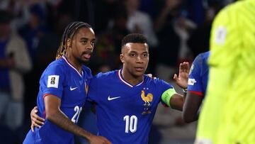 France's forward #20 Bradley Barcola (L) celebrates with France's forward #10 Kylian Mbappe (C) after scoring his team's second goal during the FIFA World Cup 2026 Group D European qualification football match between France and Iceland at the Parc des Princes stadium in Paris, on September 9, 2025. (Photo by FRANCK FIFE / AFP)