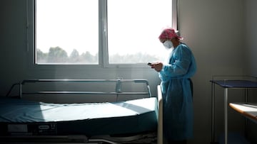 FILE PHOTO: A member of the medical staff sends a message on her mobile phone during a break as she works in the Intensive Care Unit (ICU) for coronavirus disease (COVID-19) patients at the Clinique de l'Estree private hospital in Stains near Paris,