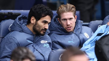Manchester City's German midfielder #19 Ilkay Gundogan (L) and Manchester City's Belgian midfielder #17 Kevin De Bruyne (R) take their places on the bench ahead of kick-off in the English Premier League football match between Manchester City and Everton at the Etihad Stadium in Manchester, north west England, on December 26, 2024. (Photo by Darren Staples / AFP) / RESTRICTED TO EDITORIAL USE. No use with unauthorized audio, video, data, fixture lists, club/league logos or 'live' services. Online in-match use limited to 120 images. An additional 40 images may be used in extra time. No video emulation. Social media in-match use limited to 120 images. An additional 40 images may be used in extra time. No use in betting publications, games or single club/league/player publications. /