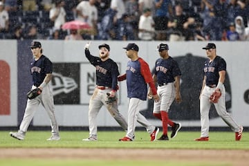 NEW YORK, NY - JULY 17: Alex Verdugo #99 of the Boston Red Sox reacts as he walks off the field with Alex Cora #13 of the Boston Red Sox during the sixth inning against the New York Yankees at Yankee Stadium on July 17, 2021 in the Bronx borough of New Yo