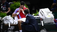 Serbia's Novak Djokovic receives medical advice during his men's singles match against Netherlands' Tallon Griekspoor on day four of the Paris ATP Masters 1000 tennis tournament at the Accor Arena - Palais Omnisports de Paris-Bercy - in Paris on November 2, 2023. (Photo by JULIEN DE ROSA / AFP)