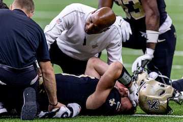 Dec 1, 2024; New Orleans, Louisiana, USA;  New Orleans Saints tight end Taysom Hill (7) is injured after a tackle by Los Angeles Rams cornerback Cobie Durant (14) and has to be carted off the field during the second half at Caesars Superdome. Mandatory Credit: Stephen Lew-Imagn Images