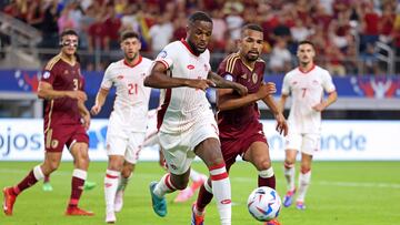 Canada's forward #09 Cyle Larin (C) fights for the ball with Venezuela's midfielder #06 Yangel Herrera (2nd R) during the Conmebol 2024 Copa America tournament quarter-final football match between Venezuela and Canada at AT&T Stadium in Arlington, Texas, on July 5, 2024. (Photo by CHARLY TRIBALLEAU / AFP)