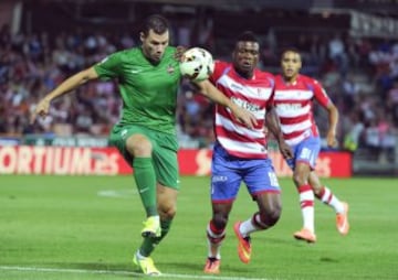 El delantero mexicano del Granada Jhon Córdoba pelea un balón con David Navarro, del Levante, durante el partido de Liga en Primera División disputado esta noche en el estadio Nuevo Los Cármenes, en Granada.