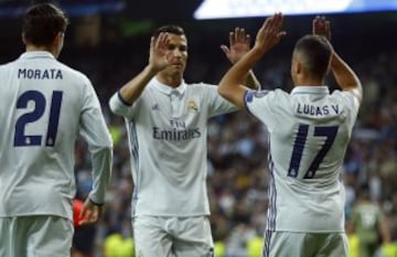 Real Madrid's Lucas Vazquez, right, celebrates with teammate Cristiano Ronaldo after scoring his side's fourth goal during a Champions League, Group F soccer match between Real Madrid and Legia Warsaw, at the Santiago Bernabeu stadium in Madrid, Tuesday, 