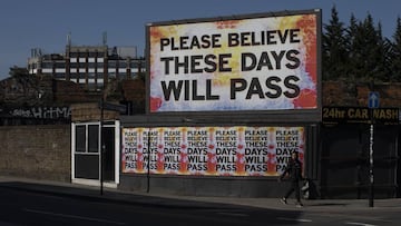 A woman walks past street art on April 21, 2020 in London,