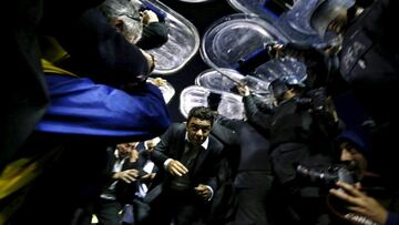River Plate's head coach Marcelo Gallardo (C) is heavily guarded by police after their Copa Libertadores soccer match against Boca Juniors was suspended in Buenos Aires May 14, 2015. REUTERS/Marcos Brindicci