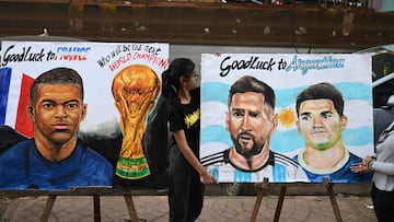 Students adjust paintings of Argentina's forward Lionel Messi and France's forward Kylian Mbapp� ahead of the Qatar 2022 FIFA World Cup football final match between France and Argentina, at an art school in Mumbai on December 16, 2022. (Photo by Punit PARANJPE / AFP)