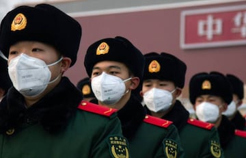 Chinese police officers wearing masks stand in front of the Tiananmen Gate on January 26, 2020 in Beijing, China. The number of cases of coronavirus rose to 1,975 in mainland China on Sunday.