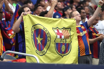 Fans hold up an FC Barcelona flag 