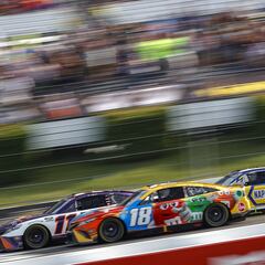 Why were Denny Hamlin and Kyle Busch disqualified from the NASCAR race at Pocono?