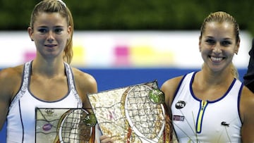 Slovakia&#039;s Dominika Cibulkova (r) poses with her trophy after beating Italy&#039;s Camila Giorgi in the WTA Katowice Open tennis final.