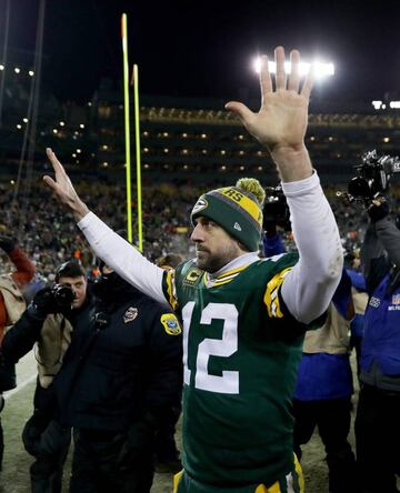 Aaron Rodgers of the Green Bay Packers walks off the field after beating the New York Giants 38-13 in the NFC Wild Card game at Lambeau Field