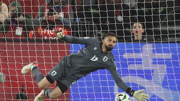 Georgia's goalkeeper #12 Giorgi Mamardashvili saves a penalty in the penalty shoot-out during the UEFA EURO 2024 qualifying play-off final football match between Georgia and Greece in Tbilisi on March 26, 2024. (Photo by Giorgi ARJEVANIDZE / AFP)