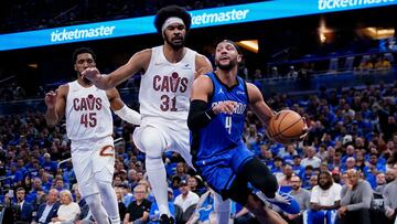 ORLANDO, FLORIDA - APRIL 25: Jalen Suggs #4 of the Orlando Magic dribbles the ball against Jarrett Allen #31 of the Cleveland Cavaliers during the first quarter of game three of the Eastern Conference First Round Playoffs at Kia Center on April 25, 2024 in Orlando, Florida. NOTE TO USER: User expressly acknowledges and agrees that, by downloading and or using this photograph, User is consenting to the terms and conditions of the Getty Images License Agreement.   Rich Storry/Getty Images/AFP (Photo by Rich Storry / GETTY IMAGES NORTH AMERICA / Getty Images via AFP)