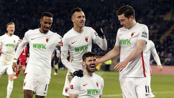 Augsburg&#039;s Daniel Caligiuri, front, celebrates scoring with teammates during the Bundesliga soccer match between  Arminia Bielefeld and FC Augsburg at Schuco Arena, Bielefeld, Germany, Friday March 4, 2022. (Friso Gentsch/dpa via AP)