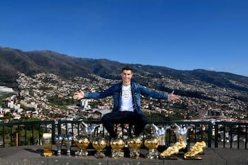 Ronaldo poses in front of his haul of trophies.