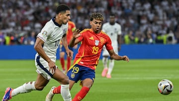 England's midfielder #10 Jude Bellingham fights for the ball with Spain's forward #19 Lamine Yamal during the UEFA Euro 2024 final football match between Spain and England at the Olympiastadion in Berlin on July 14, 2024. (Photo by INA FASSBENDER / AFP)