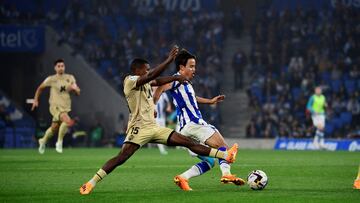 Almeria's Spanish defender Sergio Akieme (L) fights for the ball with Real Sociedad's Japanese forward Takefusa Kubo during the Spanish league football match between Real Sociedad and UD Almeria at the Reale Arena stadium in San Sebastian on May 23, 2023. (Photo by ANDER GILLENEA / AFP)