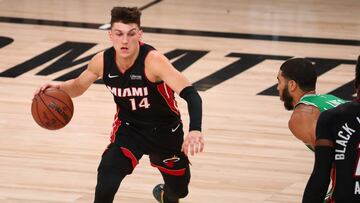 Sep 23, 2020; Lake Buena Vista, Florida, USA; Miami Heat guard Tyler Herro (14) dribbles against Boston Celtics forward Jayson Tatum (right) during the first half of game four of the Eastern Conference Finals of the 2020 NBA Playoffs at AdventHealth Arena. Mandatory Credit: Kim Klement-USA TODAY Sports