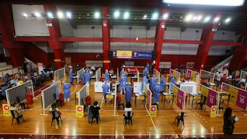 FILE PHOTO: People wait to receive doses of Russia&#039;s Sputnik V vaccine against the coronavirus disease (COVID-19) at the basket ball court at the River Plate stadium, in Buenos Aires, Argentina February 3, 2021. REUTERS/Matias Baglietto/File Photo