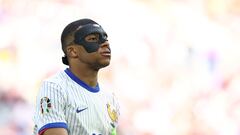 France's forward #10 Kylian Mbappe, wearing a protective mask, looks on during the UEFA Euro 2024 round of 16 football match between France and Belgium at the Duesseldorf Arena in Duesseldorf on July 1, 2024. (Photo by FRANCK FIFE / AFP)