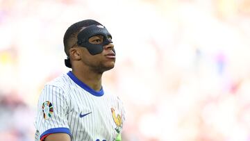 France's forward #10 Kylian Mbappe, wearing a protective mask, looks on during the UEFA Euro 2024 round of 16 football match between France and Belgium at the Duesseldorf Arena in Duesseldorf on July 1, 2024. (Photo by FRANCK FIFE / AFP)