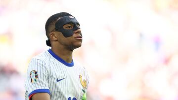 France's forward #10 Kylian Mbappe, wearing a protective mask, looks on during the UEFA Euro 2024 round of 16 football match between France and Belgium at the Duesseldorf Arena in Duesseldorf on July 1, 2024. (Photo by FRANCK FIFE / AFP)