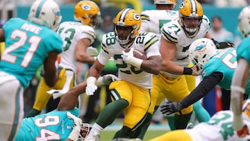 MIAMI GARDENS, FLORIDA - DECEMBER 25: AJ Dillon #28 of the Green Bay Packers carries the ball during the second quarter of the game against the Miami Dolphins at Hard Rock Stadium on December 25, 2022 in Miami Gardens, Florida.   Megan Briggs/Getty Images/AFP (Photo by Megan Briggs / GETTY IMAGES NORTH AMERICA / Getty Images via AFP)