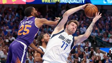 May 6, 2022; Dallas, Texas, USA; Dallas Mavericks guard Luka Doncic (77) grabs a rebound in front of Phoenix Suns forward Mikal Bridges (25) during the second quarter in game three of the second round of the 2022 NBA playoffs at American Airlines Center. Mandatory Credit: Kevin Jairaj-USA TODAY Sports