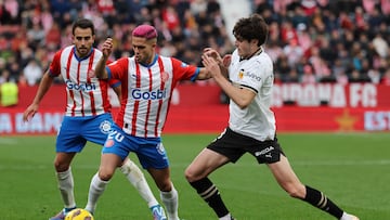 Valencia's Spanish midfielder #8 Javi Guerra (R) challenges Girona's Brazilian defender #20 Yan Couto during the Spanish league football match between Girona FC and Valencia CF at the Montilivi stadium in Girona on December 1, 2023. (Photo by LLUIS GENE / AFP)