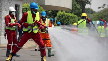 Fire service crews decontaminate a street in Abuja, Nigeria. 