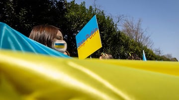 A protestor holds up an anti-Russian slogan in a protest against Russia&#039;s actions in Ukraine, during a rally in Tokyo on March 5, 2022. (Photo by Behrouz MEHRI / AFP)