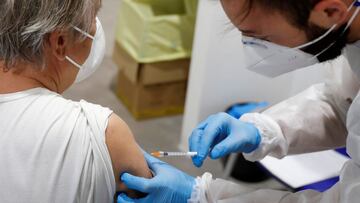 FILE PHOTO: A person receives a dose of the Moderna vaccine against the coronavirus disease (COVID-19) at the Music Auditorium in Rome, Italy, April 14, 2021. REUTERS/Yara Nardi/File Photo