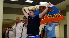 This file photo taken on June 18, 2016 shows Russia&#039;s football fans leader Alexander Shprygin holding a flag as he leaves with others fans the international airport Sheremetevo near Moscow late on June 18, 2016 after being expulsed from France after 