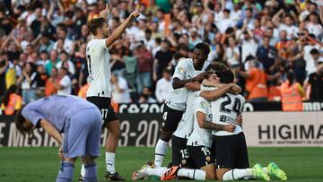 Valencia players celebrate their win at the end of the Spanish league football match between Valencia CF and Real Madrid CF at the Mestalla stadium in Valencia on May 21, 2023. (Photo by JOSE JORDAN / AFP)